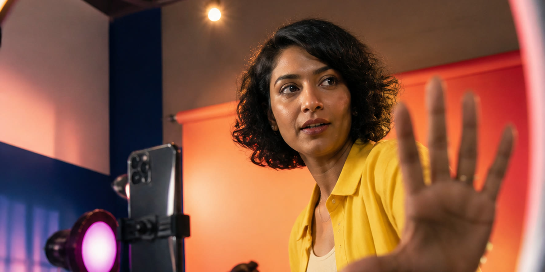 Creative director working on a colorful video production set framed by a ring light.